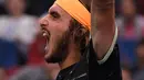 Petenis Yunani, Stefanos Tsitsipas berselebrasi setelah mengalahkan Novak Djokovic dari Serbia pada perempat final tunggal putra tenis Shanghai Masters di Qizhong Forest Sports City Tennis Center di Shanghai, China (11/10/2019). Tsitsipas menang 3-6, 7-5, 6-3 atas Djokovic. (AFP Photo/Noel Celis)