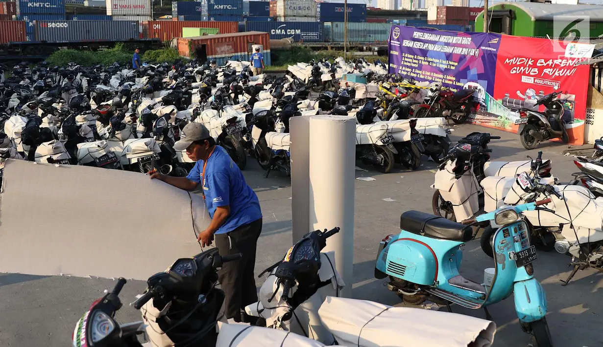 Petugas mengemas sepeda motor untuk diangkut dengan kereta api Stasiun Kampung Bandan, Jakarta, Senin (11/6). Program mudik gratis ini digagas Kemenhub tersebut melayani pengiriman ke beberapa daerah di Pulau Jawa. (Liputan6.com/Immanuel Antonius)