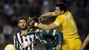 Pemain Santiago Wanderers, Carlos Gonzalez (tengah) berebut bola dengan Rodrigo Munoz (kanan) dan Pedro Benitez dari klub Libertad dalam pertandingan Copa Sudamericana di Stadion Nicolas Leoz, Asuncion, Paraguay. (18/8/2015). (Reuters/Jorge Adorno)