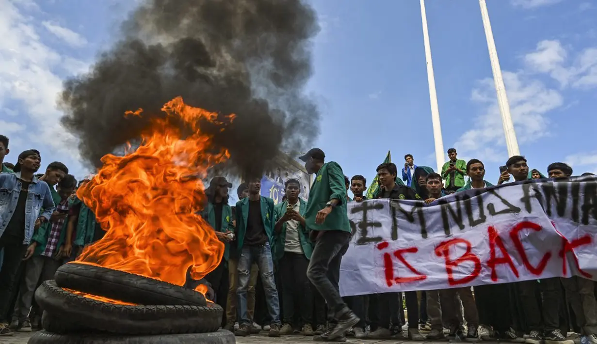 Para aksi datang membawa spanduk bertuliskan “Tolak Rohingya” sambil menyanyikan lagu Buruh Tani. Aksi juga diwarnai dengan membakar ban. (CHAIDEER MAHYUDDIN/AFP)