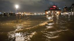 Pasar ikan dengan balai pelelangan ikan dibanjiri saat badai di Hamburg, Jerman, Kamis (17/2/2022). Badai 'Ylenia' menyapu Jerman semalam, menumbangkan pohon dan menyebabkan penundaan yang meluas pada lalu lintas kereta api dan udara. (Daniel Bockwoldt/dpa via AP)