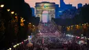 Atlet dari berbagai delegasi berparade di jalan Champs-Elysees dengan latar belakang Arc de Triomphe, pada Upacara Pembukaan Paralimpiade Paris 2024, Rabu (28/8/2024). (Dimitar DILKOFF / AFP)