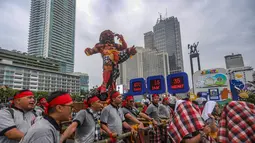 Ini merupakan bagian dari acara menyambut Hari Raya Nyepi 1948 Saka. Tampak dalam foto, warga mengarak ogoh-ogoh saat pawai budaya di kawasan Bundaran Hotel Indonesia, Jakarta, Minggu (8/3/2026). (merdeka.com/Arie Basuki)