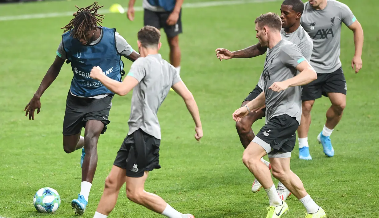 Striker Liverpool, Divock Origi (kiri) menendang bola saat mengikuti latihan di stadion Besiktas Park di Istanbul, Turki (13/8/2019). Liverpool akan bertanding melawan Chelsea dalam pertandingan Piala Super Eropa 2019 di Istanbul, Turki, Kamis (15/8/2019) dini hari WIB. (AFP Photo/Ozan Kose)