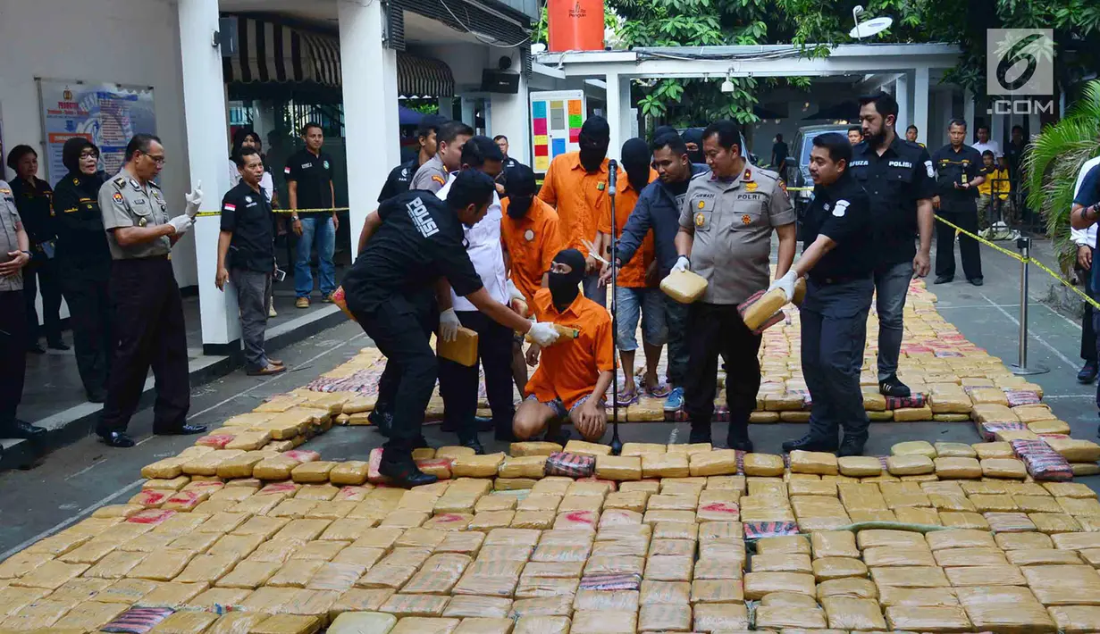 Petugas menunjukkan tersangka dan barang bukti narkoba jenis ganja saat rilis di Polda Metro, Jakarta, Senin (30/7). Sebanyak 1.434 kg ganja jaringan Aceh-Jakarta-Bogor diamankan petugas berikut 6 orang tersangka. (Merdeka.com/Arie Basuki)