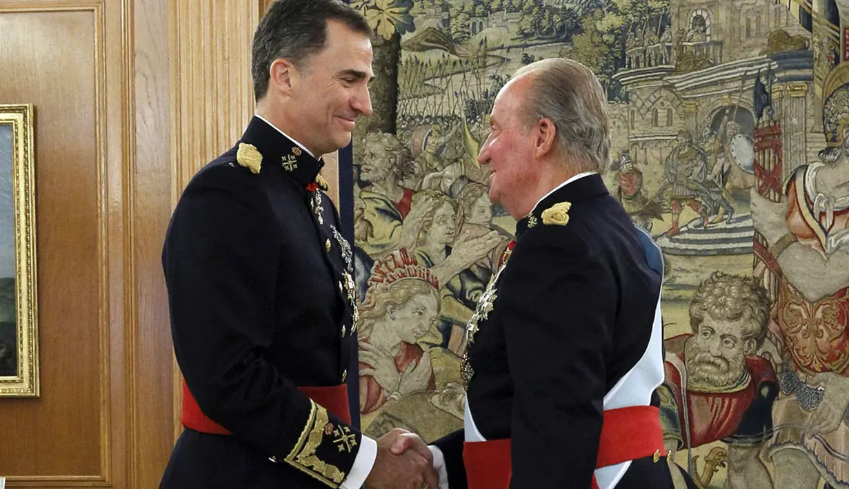 Raja Spanyol, Juan Carlos (kanan) menjabat tangan Raja Felipe VI, usai upacara pelantikan di La Zarzuela Palace, Madrid, Spanyol, (19/6/2014). (REUTERS/Zipi)