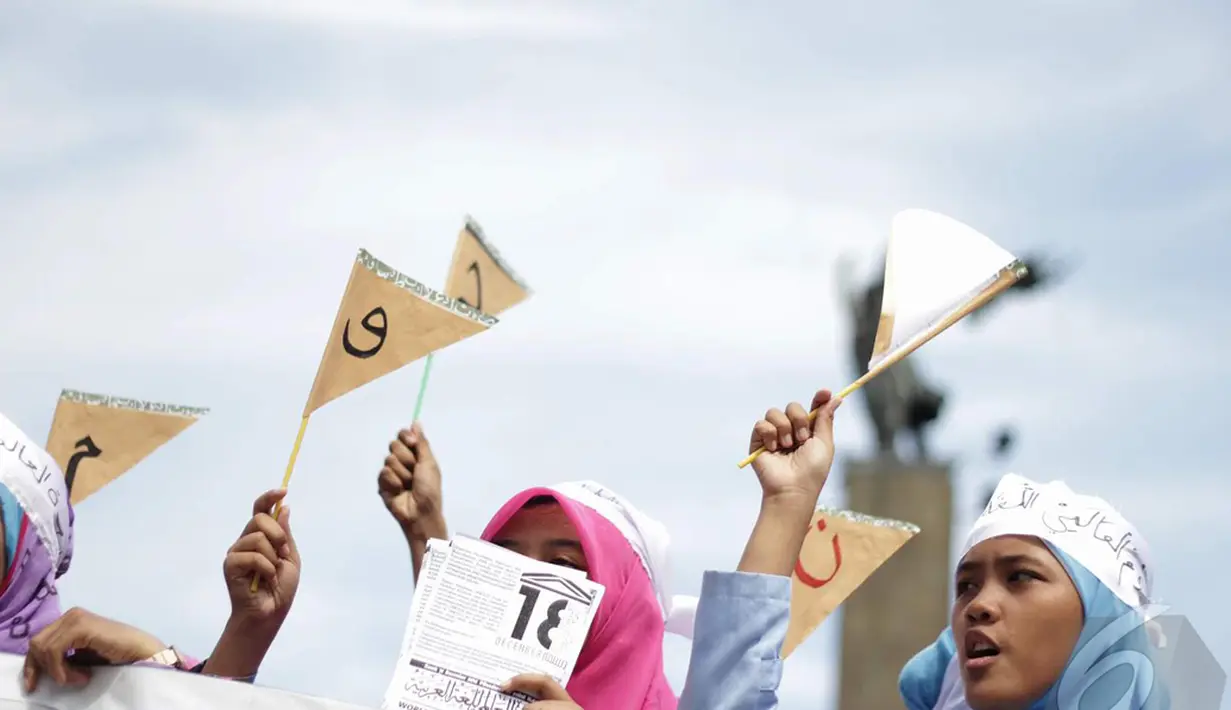 Sejumlah mahasiswa membawa atribut bergambar huruf-huruf arab saat aksi damai memperingati hari Bahasa Arab, Jakarta, Kamis (18/12/2014). ( Liputan6.com/Faizal Fanani)