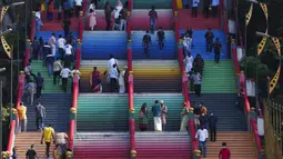 Umat Hindu menaiki tangga berwarna untuk berdoa saat Festival Diwali di Kuil Batu Caves, Kuala Lumpur, Malaysia, Kamis (4/11/2021). Diwali adalah salah satu festival terpenting dalam agama Hindu, didedikasikan untuk penyembahan dewi kekayaan Lakshmi. (AP Photo/Vincent Thian)