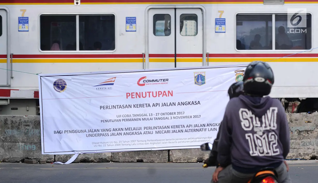 Pengendara melintas di depan spanduk sosialisasi penutupan perlintasan kereta di Jalan Angkasa, Jakarta, Minggu (15/10). Penutupan secara permanen perlintasan KA di Jalan Angkasa akan dilakukan pada 3 November mendatang. (Liputan6.com/Helmi Fithriansyah)