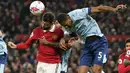 Bek Brentford, Ethan Pinnock (kanan) berduel udara dengan gelandang Manchester United, Bruno Fernandes pada laga lanjutan Liga Inggris 2022/2023 di Old Trafford Stadium, Manchester, Kamis (6/4/2023) dini hari WIB. (AP Photo/Dave Thompson)