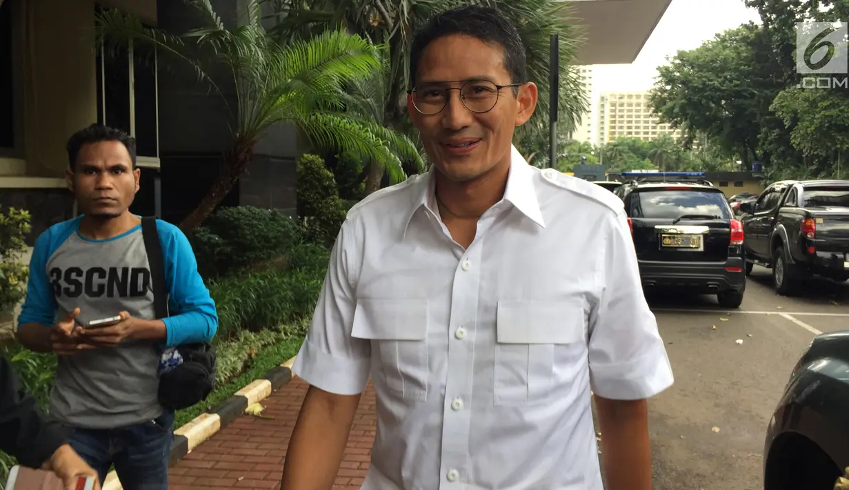 Wakil Gubernur DKI Jakarta Sandiaga Uno tersenyum saat tiba di Polda Metro Jaya, Jakarta, Selasa (30/1). Sandi mengaku siap diperiksa dan tidak membawa dokumen atau bukti yang bisa melepaskannya dari tudingan penggelapan. (Liputan6.com/Immanuel Antonius)