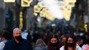 Pejalan kaki melintas di jalan perbelanjaan Roma, Italia pada Kamis (23/12/2021). Pemerintah Italia telah mewajibkan kembali penggunaan masker di luar ruangan untuk menahan peningkatan kasus Covid-19 yang didorong oleh varian Omicron. (Filippo MONTEFORTE/AFP)
