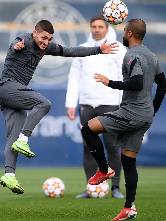 Gelandang PSG, Marco Verratti (kiri) mengontrol bola di sebelah gelandang Rafinha selama sesi latihan di tempat latihan Paris Saint-Germain di Saint Germain-en-Laye, barat Paris, Senin (18/10/2021). Saat ini, PSG memimpin Grup A UCL dengan empat angka. (AFP/Franck Fife)