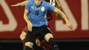 Gelandang timnas Uruguay, Federico Valverde (kiri) dan bek Venezuela, Luis Del Pino Mago berebut bola dalam lanjutan kualifikasi Piala Dunia 2022 di Stadion Olimpico de la UCV, Caracas, Rabu (9/6/2021) pagi WIB. Uruguay ditahan imbang tanpa gol oleh Venezuela. (MANAURE QUINTERO/POOL/AFP)