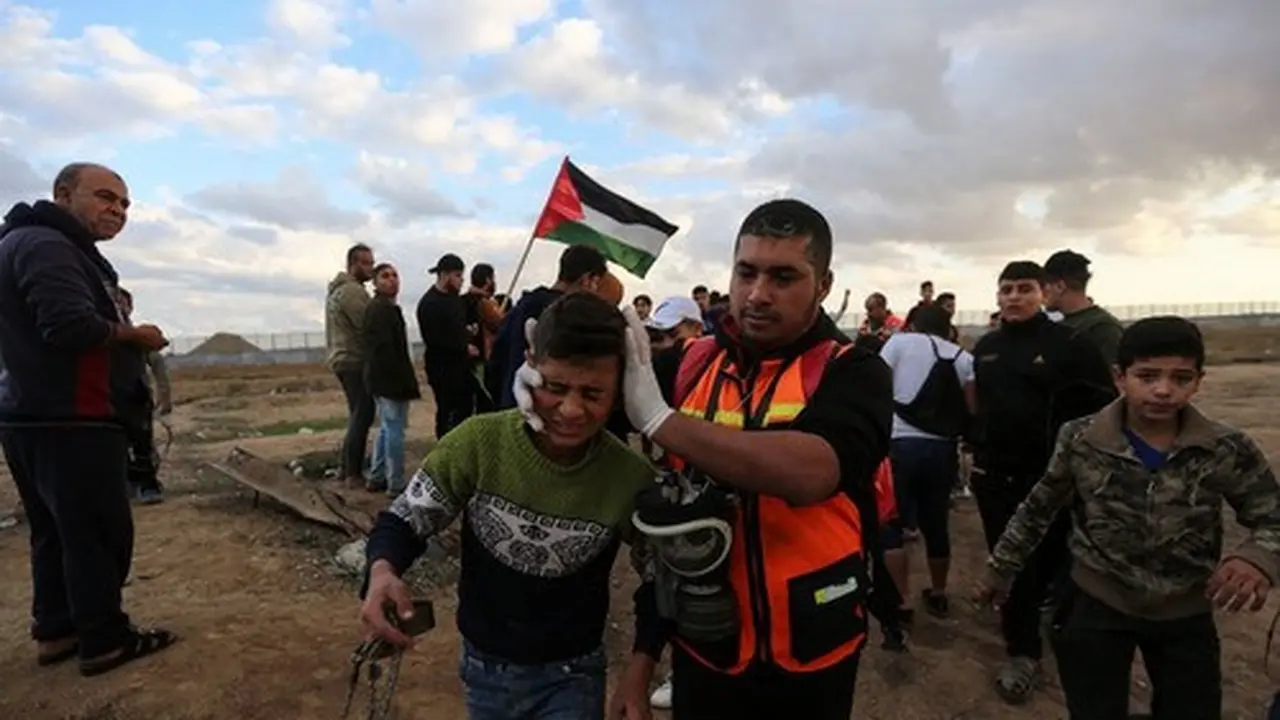 Petugas medis Palestina membantu seorang anak laki-laki yang terluka dalam bentrokan dengan tentara Israel di dekat wilayah perbatasan dengan Israel, Kota Gaza timur, pada 6 Desember 2019. (Xinhua/Mohammed Dahman)