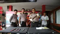 Kapolres Bangkalan, AKBP Anissullah M Ridha menunjukkan barang bukti senapan angin dan senjata tajam yang digunakan menganiyaan Sirin. (Liputan6.com/Musthofa Aldo)