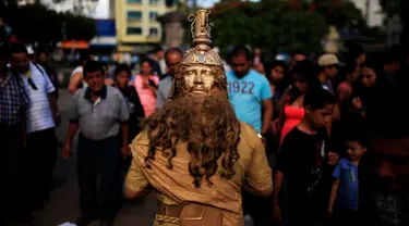 Seorang kontestan beraksi saat mengikuti kontes patung di pusat kota San Salvador , El Salvador, (18/6). Kontes ini menjadi tontonan warga El Savador yang sedang melintas. (REUTERS / Jose Cabezas)
