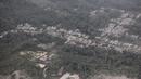 Sebuah desa tertutup abu letusan Gunung Semeru di Kabupaten Lumajang, Provinsi Jawa Timur, Minggu (5/12/2021). Badan Nasional Penanggulangan Bencana (BNPB) menyatakan, korban meninggal akibat Gunung Semeru meletus mencapai 13 orang. Sementara 41 orang yang mengalami luka-luka. (AP Photo/Trisnadi)