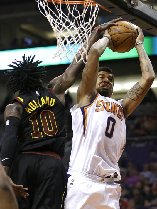 Pebasket Cleveland Cavaliers, John Holland, berebut bola dengan pebasket Phoenix Suns, Marquese Chriss, pada laga NBA di Talking Stick Resort Arena, Rabu (14/3/2018). Cleveland Cavaliers menang 129-107 atas Phoenix Suns. (AP/Rick Scuteri)
