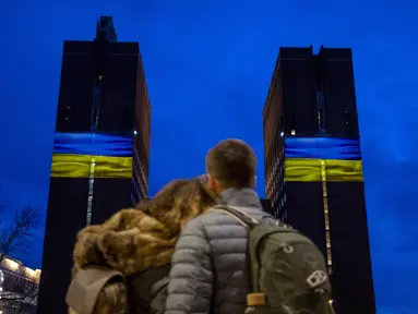 Balai Kota Oslo diterangi dengan warna-warni bendera Ukraina, di Oslo, Norwegia, Kamis malam (24/2/2022). Warna kuning dan biru menerangi bangunan tersebut dimaksudkan sebagai tindakan simbolis solidaritas dengan Ukraina. (Javad Parsa/NTB via AP)