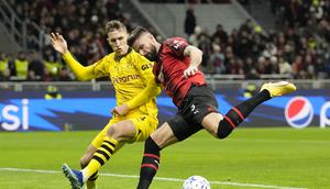 Olivier Giroud dari AC Milan, kanan, berebut bola dengan pemain Dortmund Nico Schlotterbeck pada pertandingan sepak bola grup F Liga Champions antara AC Milan dan Borussia Dortmund di stadion San Siro di Milan, Italia, Selasa, 28 November 2023. (AP Photo /Antonio Calanni)