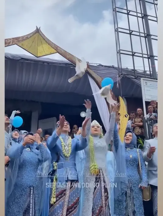 Rizki dan Hersa tampak melepas burung merpati warna putih. Pelepasan burung sebagai penanda kepergian para pengantin dari keluarganya masing-masing untuk memulai hidup bersama. [Instagram/setiastiweddingplan]