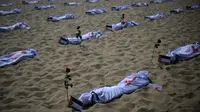 Gambar dari total 120 kain kafan yang diwarnai dengan cat merah dan ditandai dengan bendera Palestina yang dipasang oleh LSM Rio de Paz di Pantai Copacabana di Rio de Janeiro, Brasil, Jumat (3/11/2023). (Carl DE SOUZA / AFP)