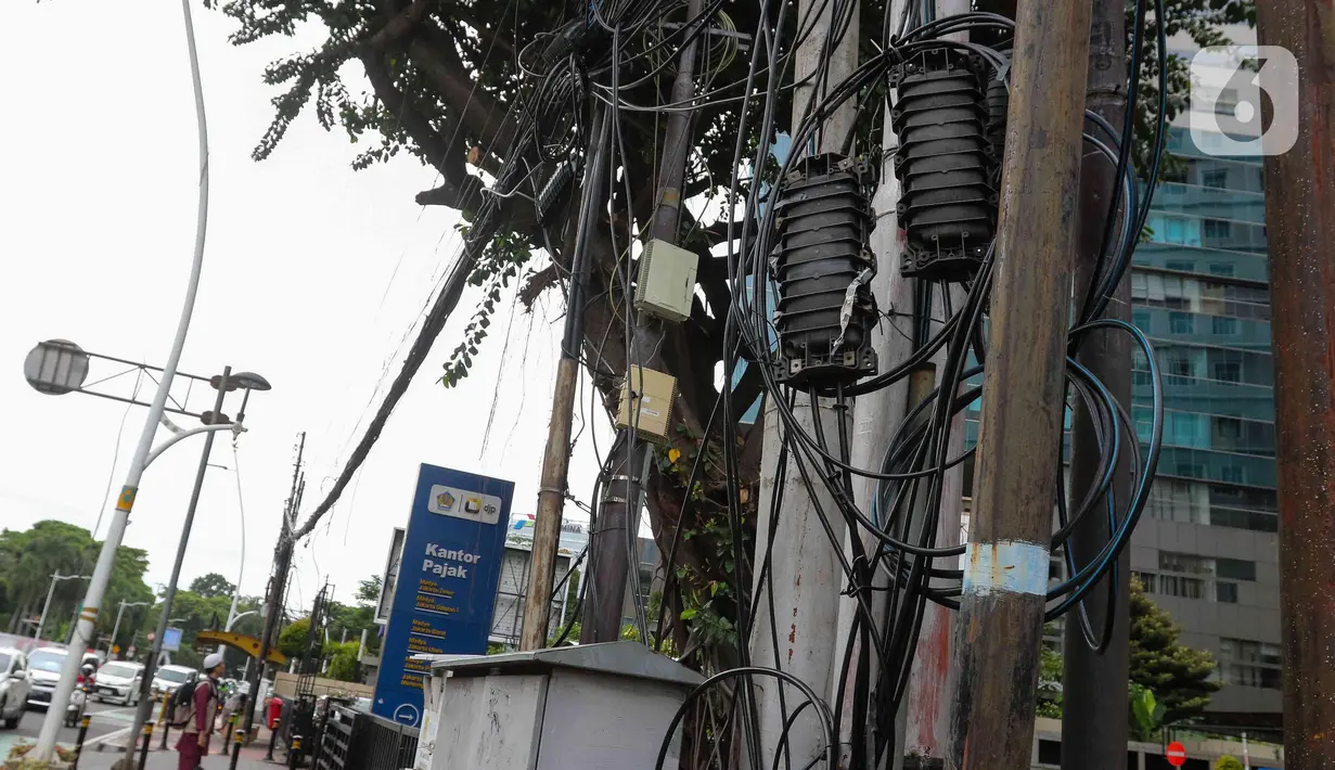 Jaringan kabel utilitas terlihat semrawut di Kawasan Jalan Medan Timur, Jakarta, Selasa (15/4/2024). (Liputan6.com/Herman Zakharia)