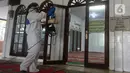 Petugas Dewan Masjid Indonesia (DMI) menyemprotkan cairan disinfektan di Masjid Hablul Muttaqin, Pejambon, Gambir, Jakarta Pusat, Jumat (6/3/2020). Kegiatan ini dilakukan untuk menjaga kebersihan masjid sekaligus mengantisipasi penyebaran virus corona (COVID-19). (Liputan6.com/Angga Yuniar)