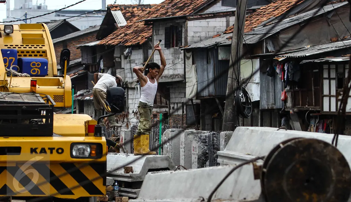 Pekerja menggarap pemasangan turap di kawasan Kali Roxy, Jakarta, Senin (14/11). Pemasangan dinding turap tersebut guna mengantisipasi luapan air kali saat musim penghujan. (Liputan6.com/Faizal Fanani)