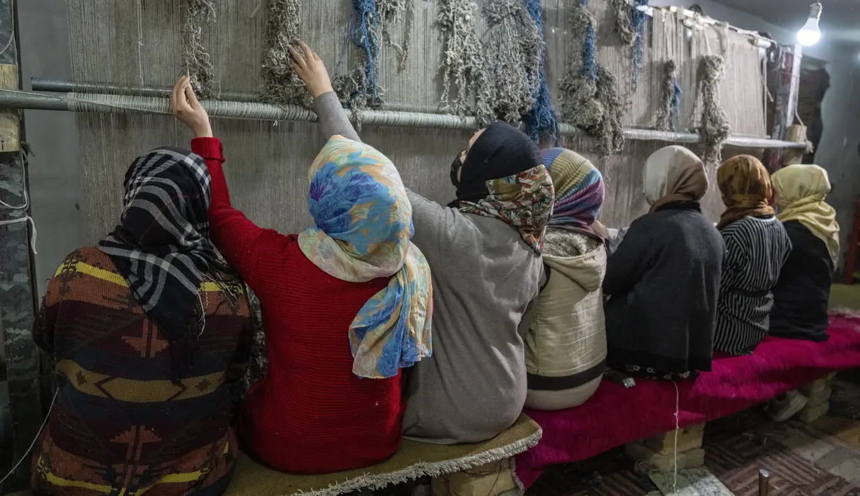 Gadis-gadis Afghanistan menenun karpet di pabrik karpet tradisional di Kabul, Afghanistan, Senin (6/3/2023). Hari Perempuan Internasional (IWD) adalah hari libur global yang dirayakan setiap tahun pada tanggal 8 Maret sebagai titik fokus dalam gerakan hak-hak perempuan, membawa perhatian pada isu-isu seperti kesetaraan gender, hak reproduksi, dan kekerasan dan pelecehan terhadap perempuan. (AP Photo/Ebrahim Noroozi)