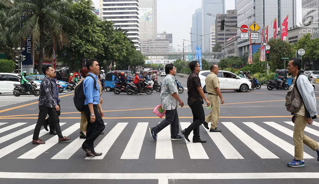 Warga menyeberangi pelican crossing di Halte Transjakarta Bank Indonesia (BI), Jakarta, Selasa (4/9). Pelican crossing diharap membuat warga memiliki kesempatan sama dalam menikmati layanan publik. (Liputan6.com/Immanuel Antonius)