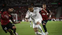 Aksi bintang Real Madrid, Kylian Mbappe saat mencoba melewati adangan pemain Mallorca pada pekan pertama La Liga 2024/2025, Senin (19/8/2024) dini hari WIB. (AP Photo/Francisco Ubilla)