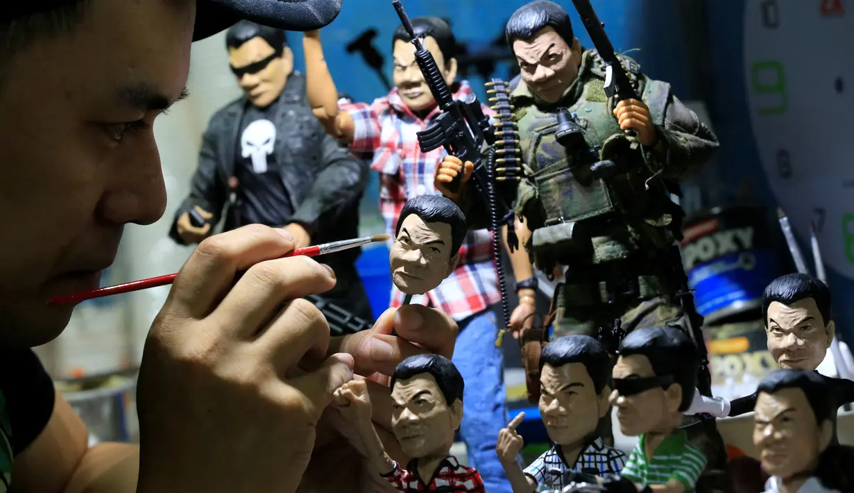 Dennis Mendoza saat menyelesaikan mainan buatannya yang merupakan karakter Presiden Filipina Rodrigo Duterte di kota Pasay , metro Manila , Filipina,(19/7). Pria 36 tahun ini menjual mainannya seharga 220 ribu hingga 1 jutaan. (REUTERS / Romeo Ranoco)