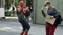 Seseorang yang mengenakan kostum Spiderman menyapa pria setelah disuntik vaksin covid-19 Pfizer-BioNTech di Mexico City, Meksiko, Selasa (28/12/2021). Spiderman tersebut dipekerjakan oleh Pemerintah Kota untuk menghibur para peserta vaksinasi. (ALFREDO ESTRELLA / AFP)