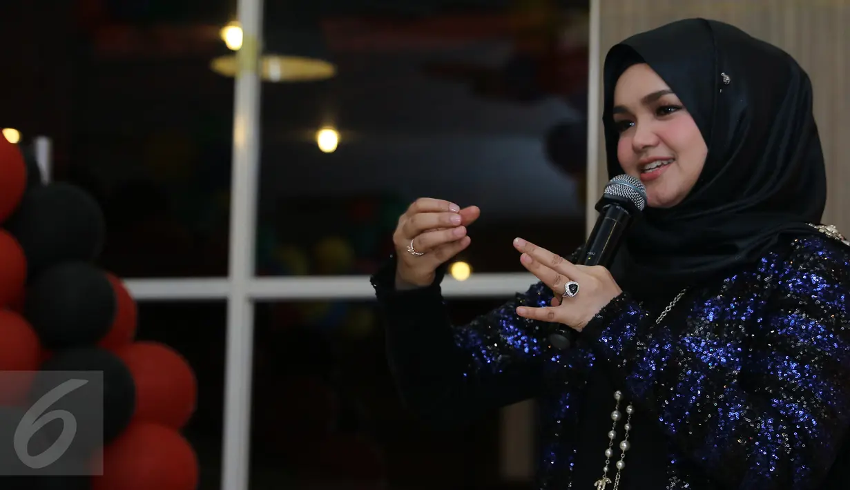 Diva asal Malaysia, Siti Nurhaliza saat merayakan ulang tahunnya ke-37 bersama para penggemarnya, Sitizoners, di restoran cepat saji di kawasan Kemang, Jakarta, Minggu (10/1). Siti Nurhaliza berulang tahun pada 11 Januari. (Liputan6.com/Herman Zakharia)
