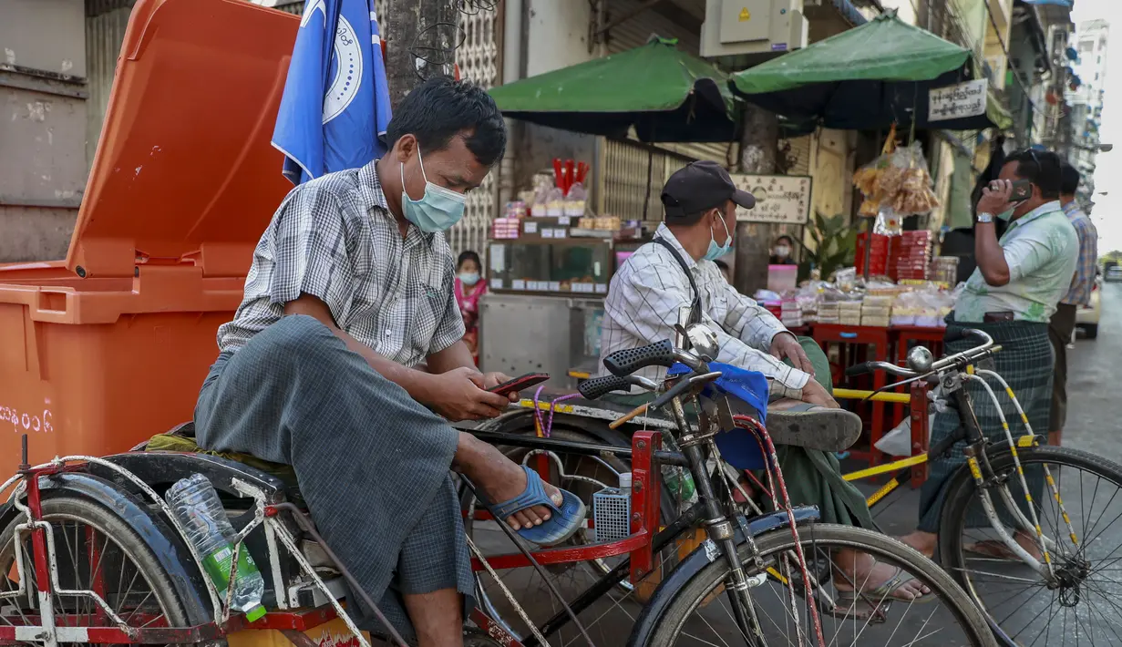 Seorang pengemudi becak memeriksa ponselnya di Yangon, Myanmar (4/2/2021).   Beberapa warga Myanmar di forum media sosial Reddit melaporkan sudah tidak bisa mengakses Facebook di ponsel mereka. (AP Photo)
