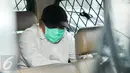 Gayus menutupi wajah dengan masker saat berada dalam mobil tahanan di PN Jakarta Selatan, (3/5/2016). Gayus sendiri tengah menjalani masa hukuman 30 tahun penjara terkait kasus pencucian uang dan penyuapan penjaga tahanan. (Liputan6.com/Yoppy Renato)