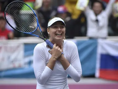 Ekspresi Maria Sharapova setelah memenangi pertandingan final tunggal wanita melawan Aryna Sabalenka dari Belarus pada turnamen tenis Tianjin Open di Tianjin (15/10). Sharapova menang 7-5 7-6 atas Sabalenka. (AFP Photo/Wang Zhao)