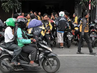 Sejumlah driver Uber mengantre untuk mendaftar menjadi pengemudi Go-Jek di kantor cabang Gunung Sahari, Jakarta, Minggu (1/4). Pasca diakuisisi oleh Grab, ratusan mantan driver Uber mendaftarkan diri menjadi mitra Go-Jek. (Merdeka.com/Iqbal S Nugroho)