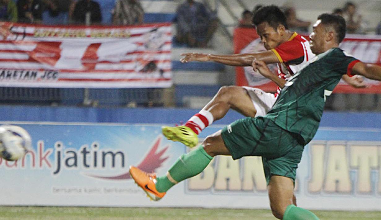 Penyerang Persepam Madura United, Sirvi Arfani (belakang) menendang kearah gawang PSS Sleman pada laga Piala Kemerdekaan di Stadion Wilis, Madiun, Sabtu (15/08/2015). Persepam berhasil taklukan PSS 2-0. (Bola.com/Robby Firly)