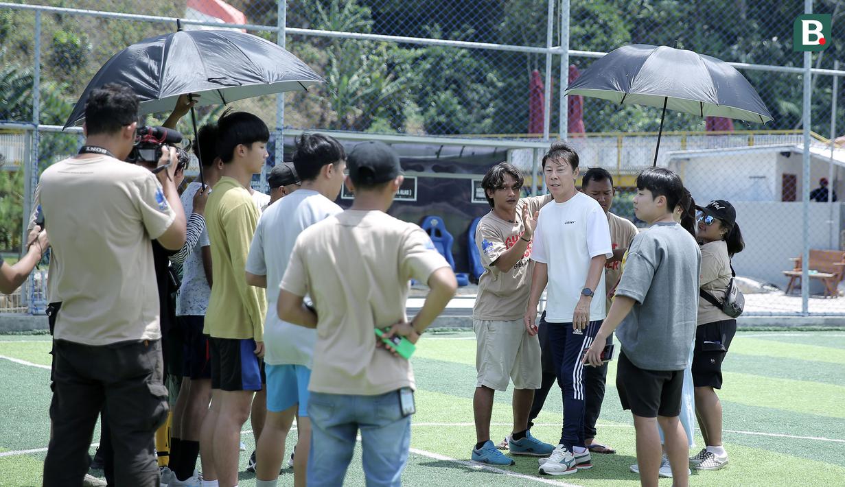 Sejumlah kru sedang melakukan briefing bersama mantan pelatih Timnas Indonesia, Shin Tae-yong saat melakukan syuting film Ghost Soccer: Bola Mati yang berlangsung di Cisalak, Subang, Jawa Barat pada Minggu (19/01/2025). (Bola.com/Rivo Falah Naufal)