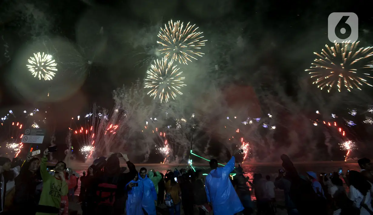 Nyala kembang api memeriahkan suasana malam pergantian tahun di Kawasan Pantai Lagoon, Taman Impian Jaya Ancol, Jakarta, Selasa (31/12/2019). Ribuan pengunjung menikmati malam pergantian tahun 2019 menuju 2020 dengan menyalakan kembang api. (merdeka.com/Imam Buhori)
