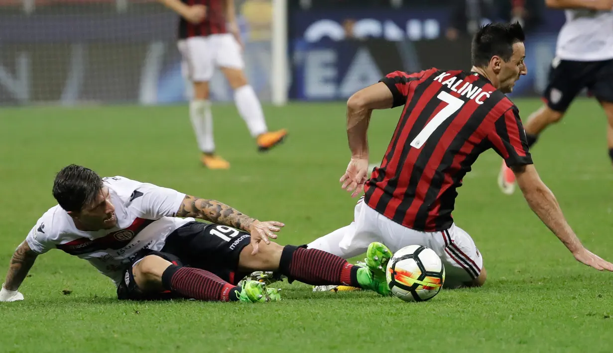 Penyerang Baru AC Milan, Nikola Kalinic (kanan) berebut bola dengan pemain Cagliari Fabio Pisacane pada lanjutan liga Serie A Italia di stadion San Siro di Milan, (27/8). AC Milan menang atas Cagliari dengan skor 2-1. (AP Photo / Luca Bruno )