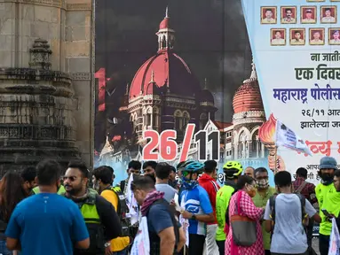 Orang-orang berkumpul di dekat Gerbang India untuk memberikan penghormatan kepada para korban serangan teroris 2008 pada peringatan 13 tahun di Mumbai (26/11/2021). Dalam peringatan itu mereka akan menggelar doa, peletakan karangan bunga, dan melakukan aksi damai. (AFP/Punit Paranjpe)