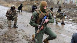 Warga sipil membawa senjata saat mengikuti sesi pelatihan militer oleh Right Sector dekat Lviv, Ukraina, 24 Februari 2023. (AP Photo/Mykola Tys)