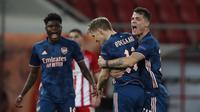 Striker Arsenal, Martin Odegaard (kedua dari kanan) melakukan selebrasi usai mencetak gol pertama timnya ke gawang Olympiakos dalam laga leg pertama babak 16 besar Liga Europa 2020/2021 di Georgios Karaiskakis Stadium, Kamis (11/3/2021). Arsenal menang 3-1 atas Olympiakos. (AP/Thanassis Stavrakis)