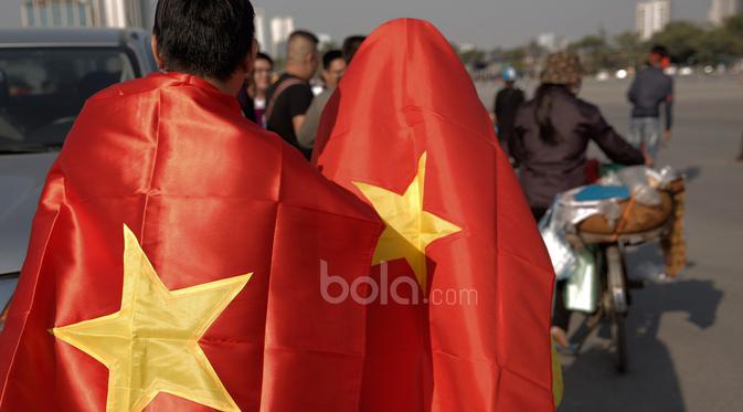 Suporter Vietnam menuju stadion berselimutkan bendera negaranya sebelum laga semifinal Piala AFF 2016 di Stadion Nasional My Dinh, (07/12/2016). (Bola.com/Peksi Cahyo)