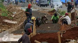 Pekerja mengerjakan pembuatan saluran air di luar Stadion Pakansari, Kabupaten Bogor, Minggu (21/8). Jelang pelaksanaan PON XIX Jawa Barat, pembangunan sarana pertandingan di Stadion Pakansari terus dikerjakan. (Liputan6.com/Helmi Fithriansyah)