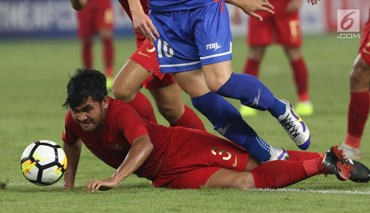 Pemain Timnas Indonesia U-19, Asnawi Mangkualam Bahar (bawah) berebut bola dengan pemain Chinnese Taipei saat laga penyisihan Grup A Piala AFC U-19 2018 di Stadion GBK, Jakarta, Kamis (18/10). (Liputan6.com/Helmi Fithriansyah)